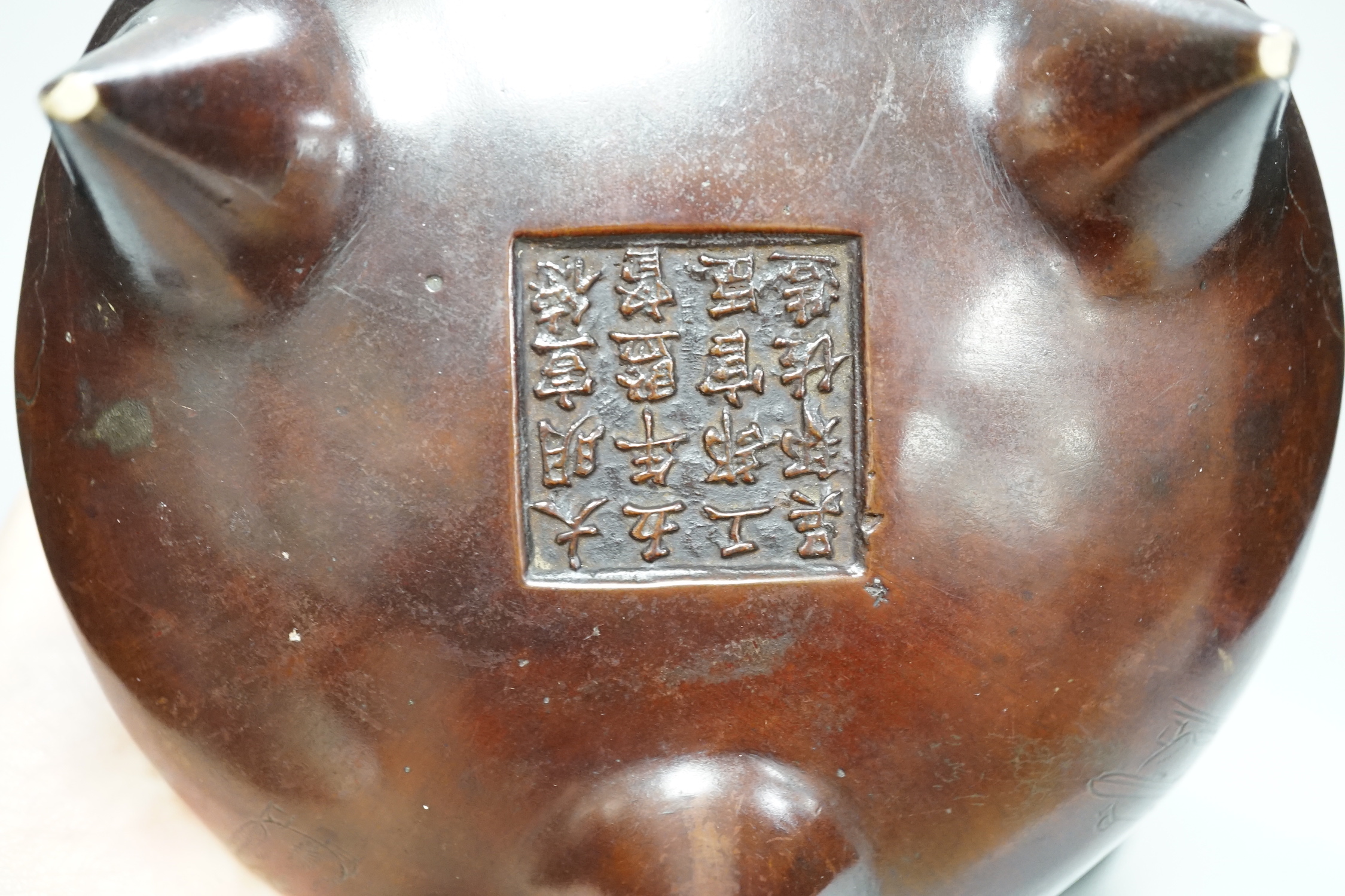 A Chinese bronze censer, with engraved detail, on hardwood stand, censer 16cm diam.